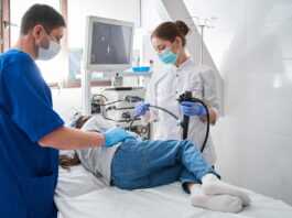 Médico realiza exame de colonoscopia em paciente durante procedimento hospitalar